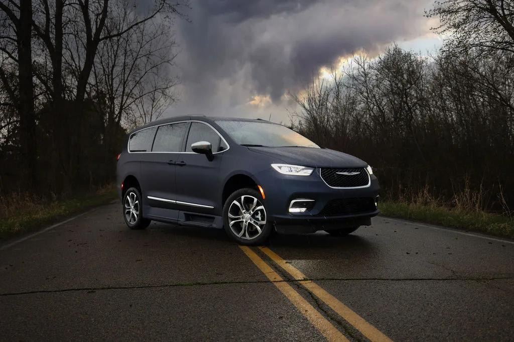 The Landfall RXS edition Chrysler Pacifica on a wet country road under a storm sky